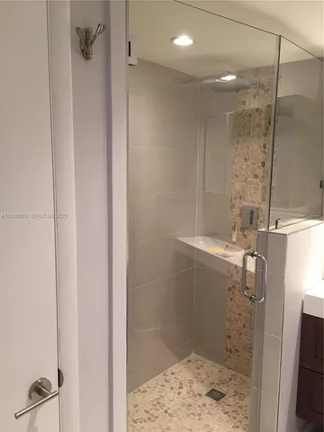 a bathroom with a shower and a sink