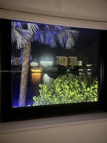 a living room view with a fireplace and a table