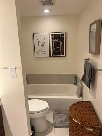 a bathroom with a toilet and a bathtub