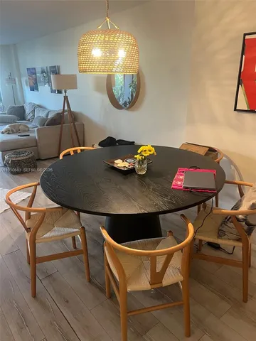a view of a dining room with furniture and chandelier
