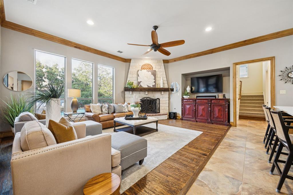 4290 Castle Bank Lane Frisco, TX 75033 - Photo 11 of 40 a living room with furniture a fireplace and a flat screen tv