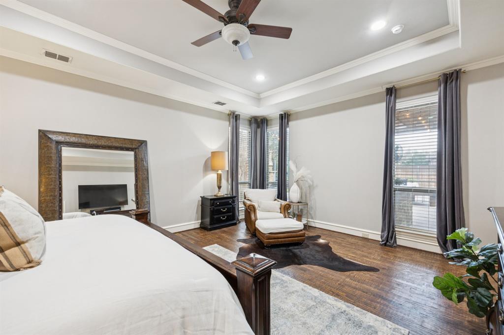 4290 Castle Bank Lane Frisco, TX 75033 - Photo 19 of 40 a bedroom with a bed and a chandelier