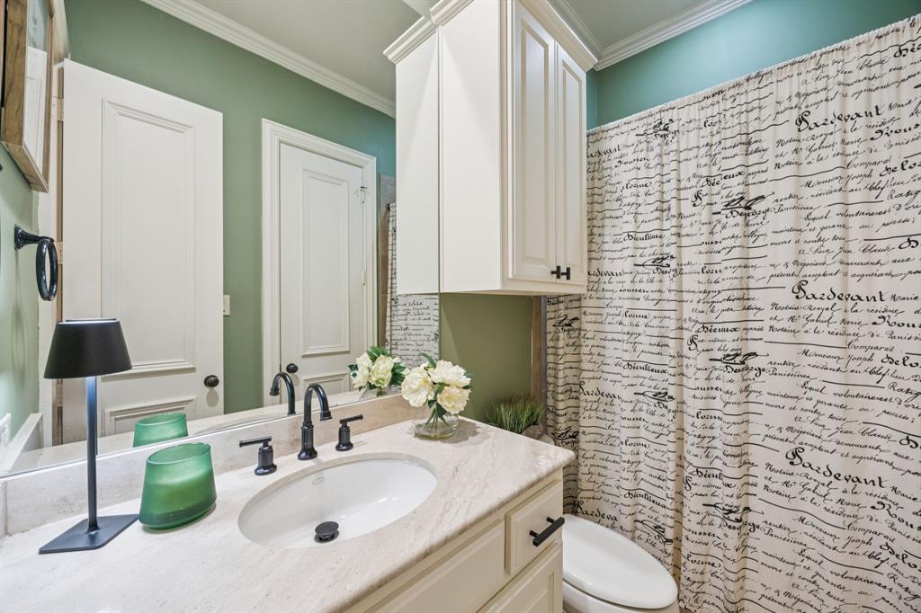 4290 Castle Bank Lane Frisco, TX 75033 - Photo 24 of 40 a bathroom with a sink a toilet and mirror