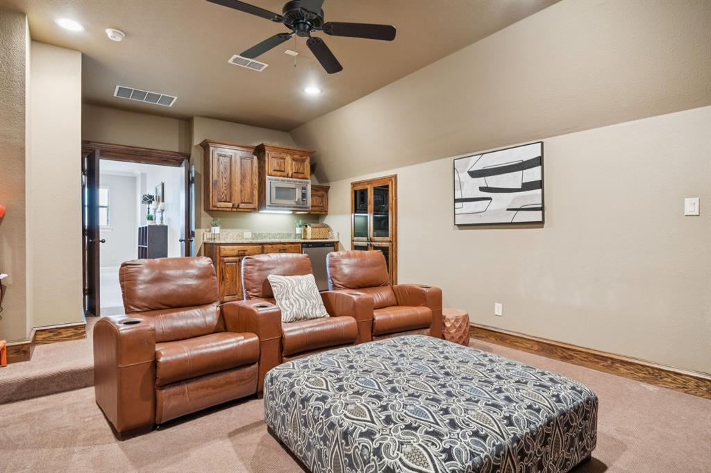 4290 Castle Bank Lane Frisco, TX 75033 - Photo 32 of 40 a living room with furniture and a rug
