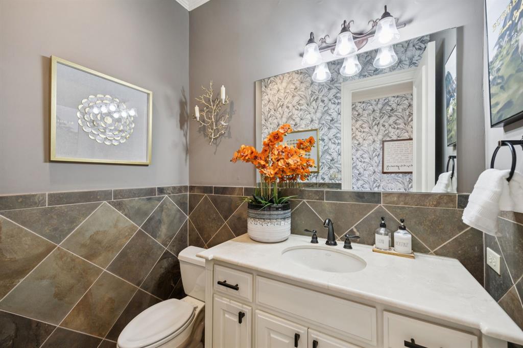 4290 Castle Bank Lane Frisco, TX 75033 - Photo 35 of 40 a bathroom with a sink vanity mirror and toilet