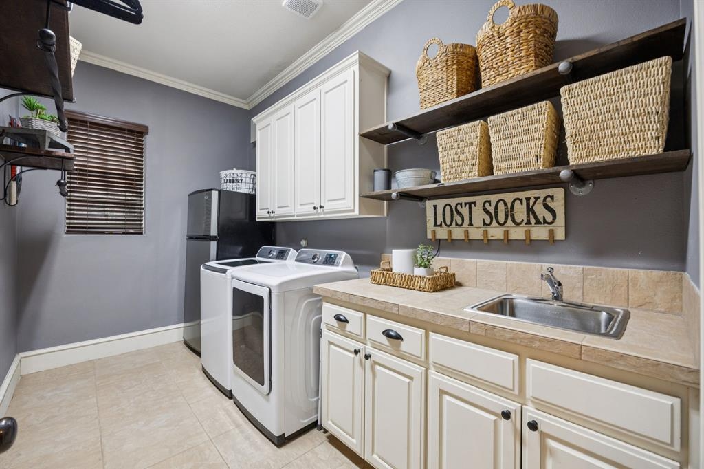 4290 Castle Bank Lane Frisco, TX 75033 - Photo 36 of 40 a kitchen with stainless steel appliances granite countertop a stove a sink and a refrigerator