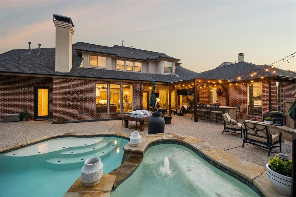 4290 Castle Bank Lane Frisco, TX 75033 - Photo 40 of 40 a living room with furniture a chandelier and a large window