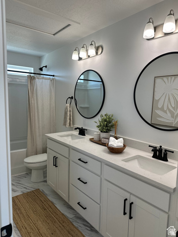 7927 Bristlecone Road, Unit 204 Eagle Mountain, UT 84005 - Photo 7 of 19 Bathroom featuring double vanity, a textured ceiling, shower / tub combo, and light marble finish flooring