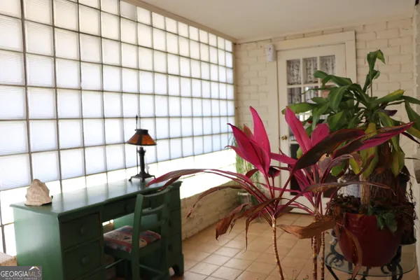 a bathroom with a window and a shower