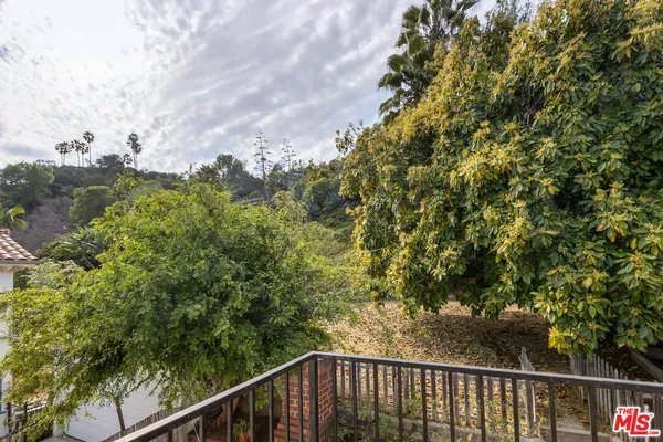 a balcony with trees in front of it
