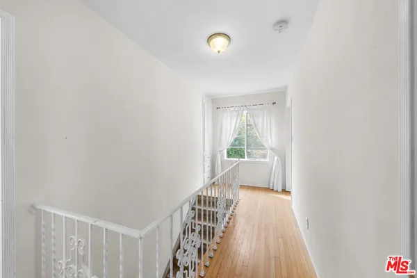 a view of hallway with wooden floor