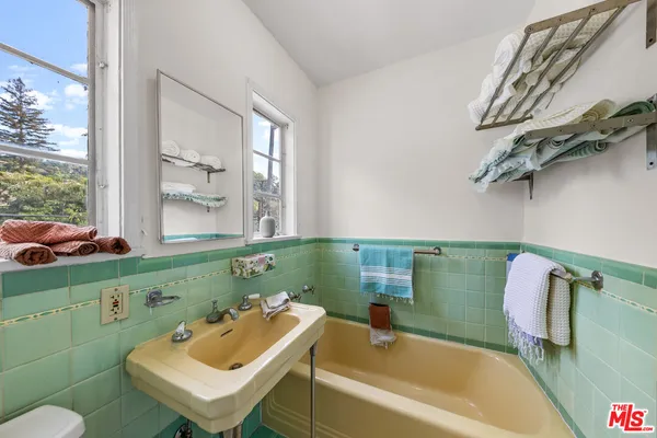 a bathroom with a sink mirror toilet and bathtub