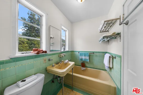 a bathroom with a sink a toilet and a bathtub