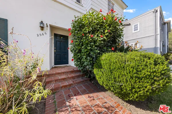 a view of a house with potted plants