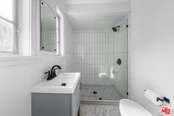 a bathroom with a sink toilet and shower