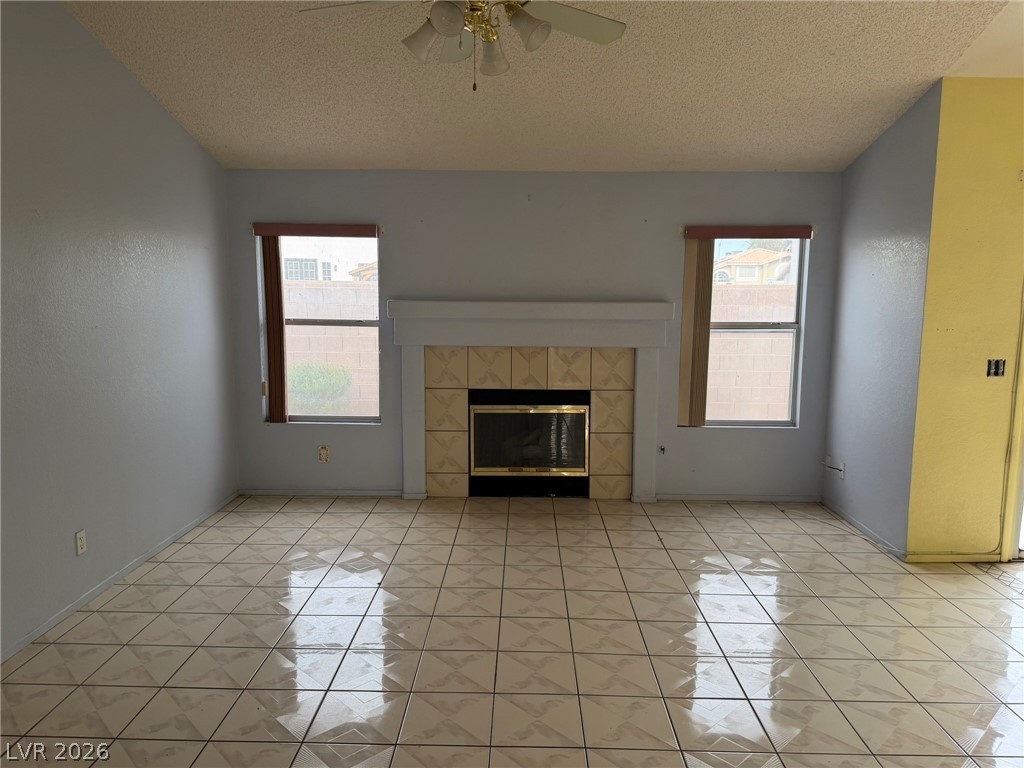 277 Gentle Bay Avenue Henderson, NV 89074 - Photo 25 of 43 This inviting living space features a cozy fireplace, perfect for creating cherished memories.