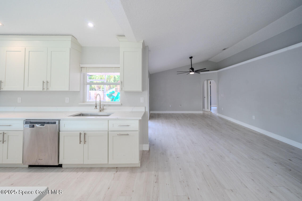 490 Tillman Avenue Southwest Palm Bay, FL 32908 - Photo 11 of 38 a kitchen with a sink cabinets and wooden floor