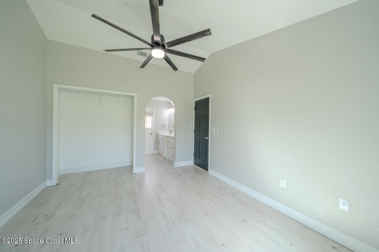 490 Tillman Avenue Southwest Palm Bay, FL 32908 - Photo 19 of 38 a view of a room with a mirror and a ceiling fan