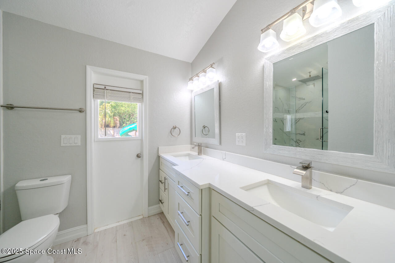 490 Tillman Avenue Southwest Palm Bay, FL 32908 - Photo 21 of 38 a bathroom with a sink and a mirror