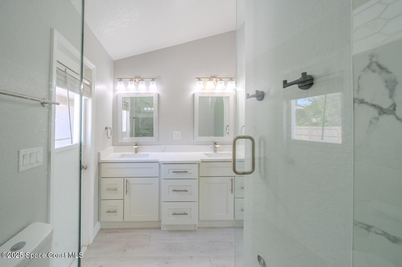 490 Tillman Avenue Southwest Palm Bay, FL 32908 - Photo 22 of 38 a bathroom with a double vanity sink mirror and shower