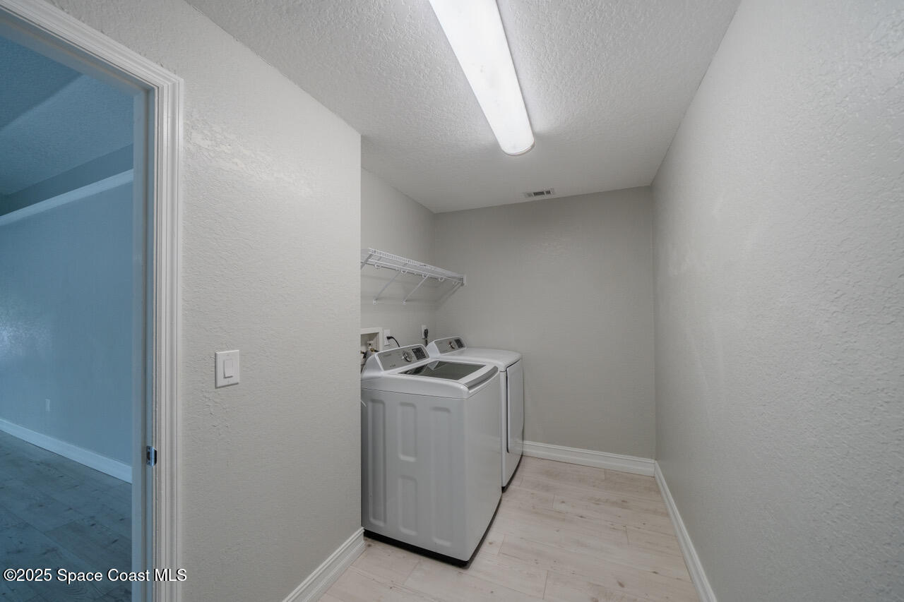 490 Tillman Avenue Southwest Palm Bay, FL 32908 - Photo 23 of 38 a utility room with cabinets washer and dryer