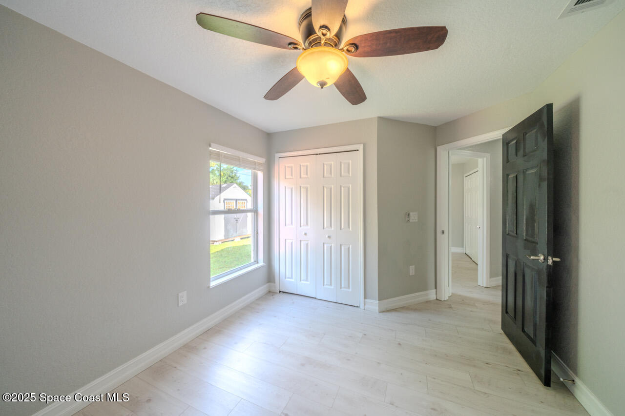 490 Tillman Avenue Southwest Palm Bay, FL 32908 - Photo 24 of 38 wooden floor in an empty room with a window