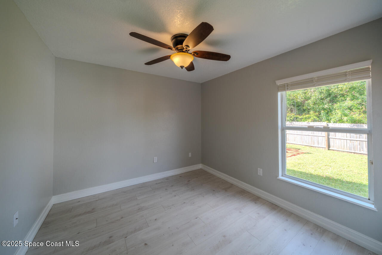 490 Tillman Avenue Southwest Palm Bay, FL 32908 - Photo 25 of 38 a view of a livingroom with a ceiling fan and window