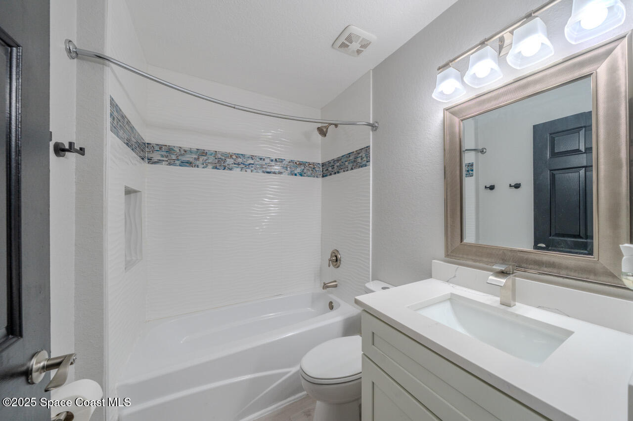 490 Tillman Avenue Southwest Palm Bay, FL 32908 - Photo 26 of 38 a bathroom with a sink a toilet and shower