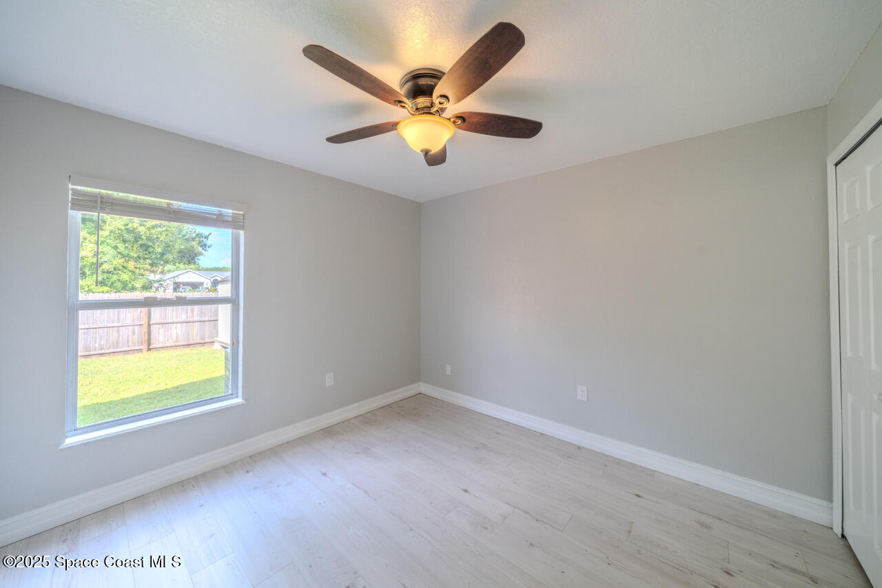 490 Tillman Avenue Southwest Palm Bay, FL 32908 - Photo 27 of 38 an empty room with a window and a ceiling fan