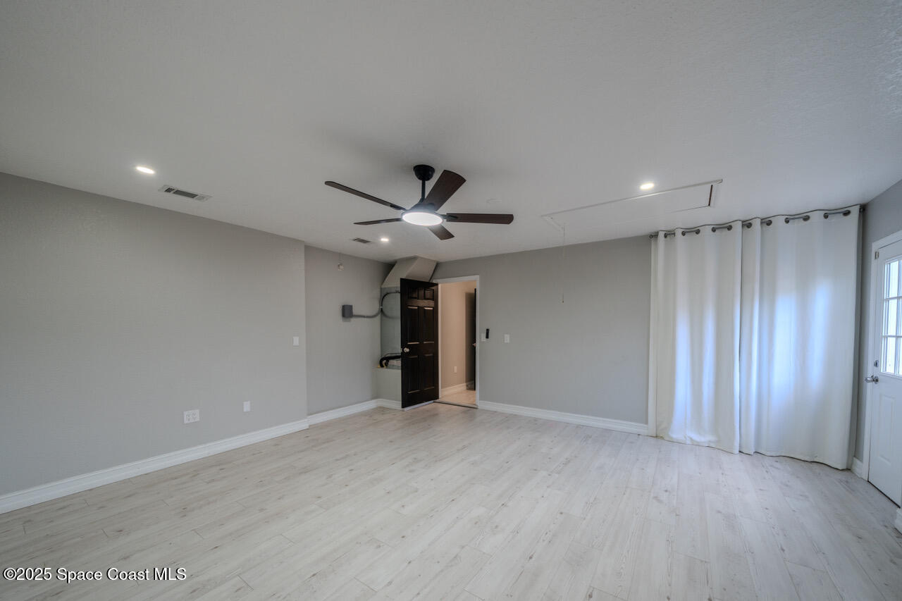 490 Tillman Avenue Southwest Palm Bay, FL 32908 - Photo 31 of 38 a view of an empty room with a ceiling fan