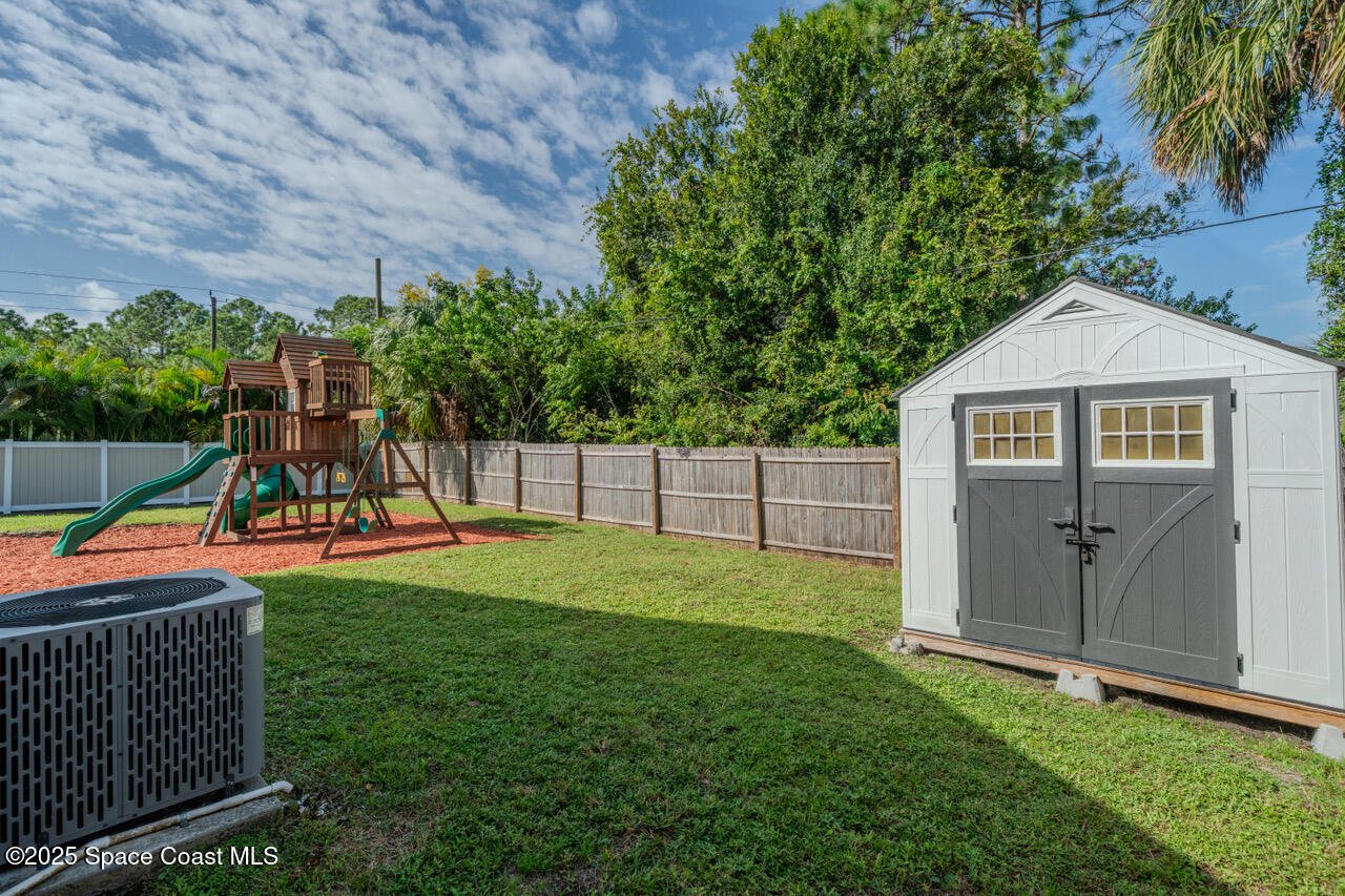 490 Tillman Avenue Southwest Palm Bay, FL 32908 - Photo 36 of 38 a view of a backyard with a garden and entertaining space