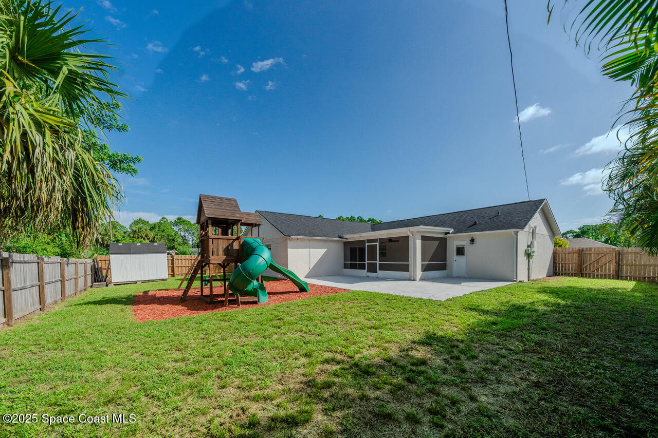 490 Tillman Avenue Southwest Palm Bay, FL 32908 - Photo 4 of 38 a view of a house with a backyard and a slide