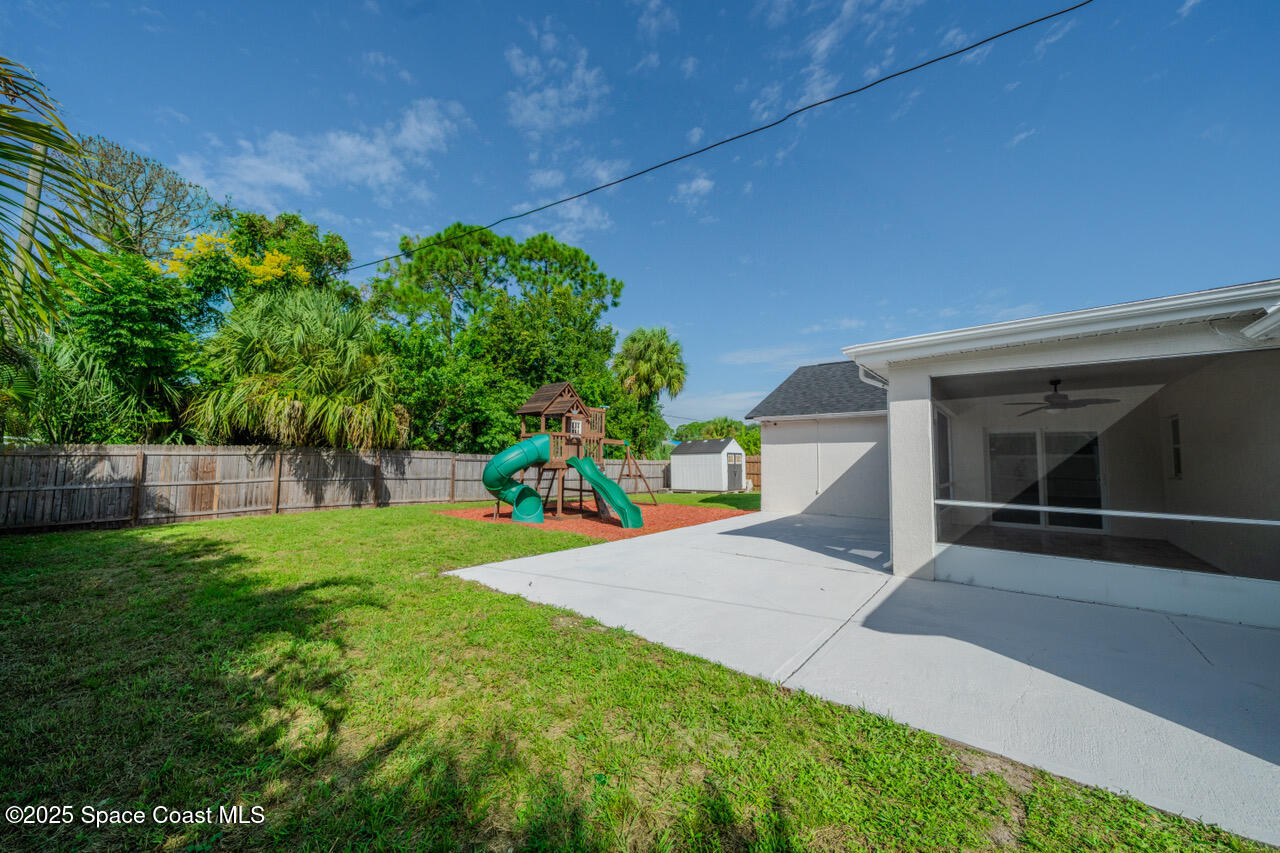 490 Tillman Avenue Southwest Palm Bay, FL 32908 - Photo 5 of 38 a view of backyard with plants and trees