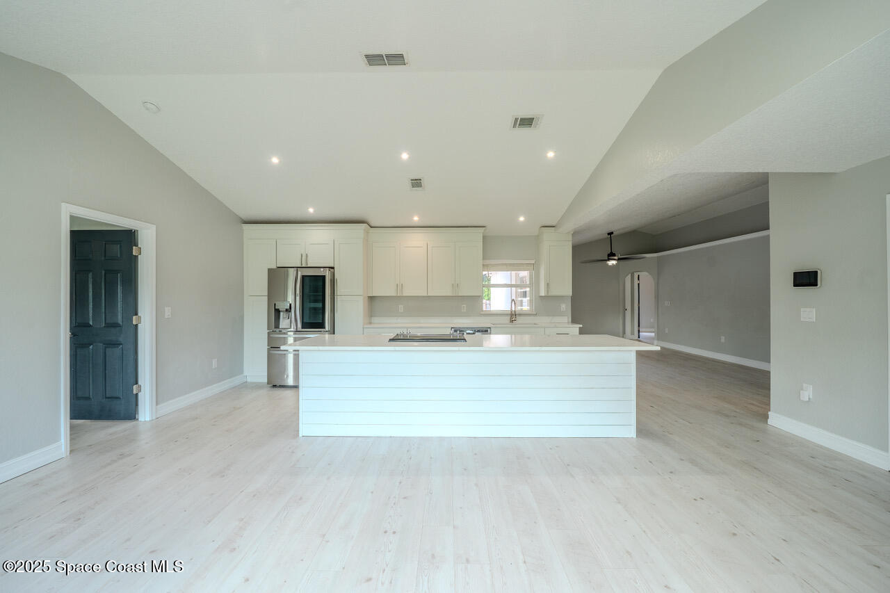 490 Tillman Avenue Southwest Palm Bay, FL 32908 - Photo 38 of 38 a view of kitchen with kitchen island a sink stainless steel appliances and cabinets