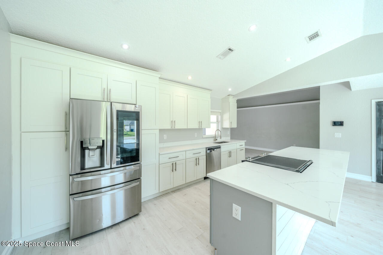 490 Tillman Avenue Southwest Palm Bay, FL 32908 - Photo 8 of 38 a kitchen with a refrigerator sink and stove
