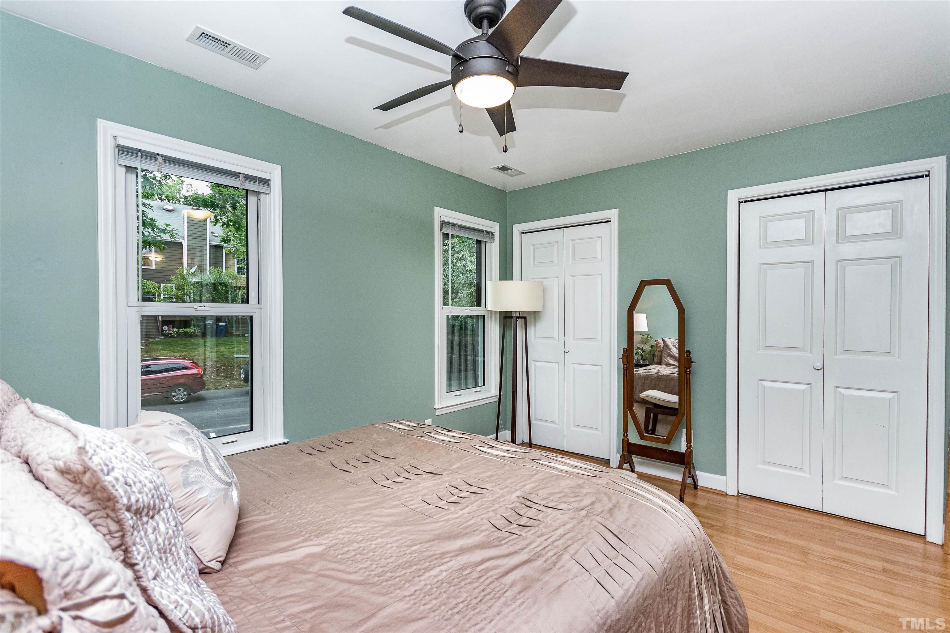 4517 Chinquoteague Court Raleigh, NC 27613 - Photo 16 of 26 a bedroom with a bed and a chandelier