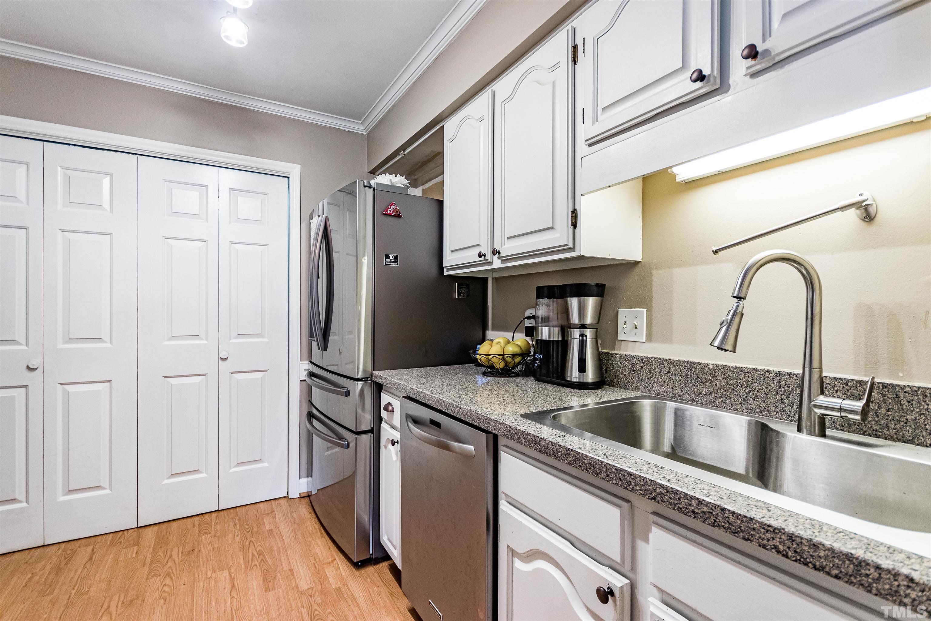 4517 Chinquoteague Court Raleigh, NC 27613 - Photo 7 of 26 a kitchen with stainless steel appliances granite countertop a refrigerator and a sink