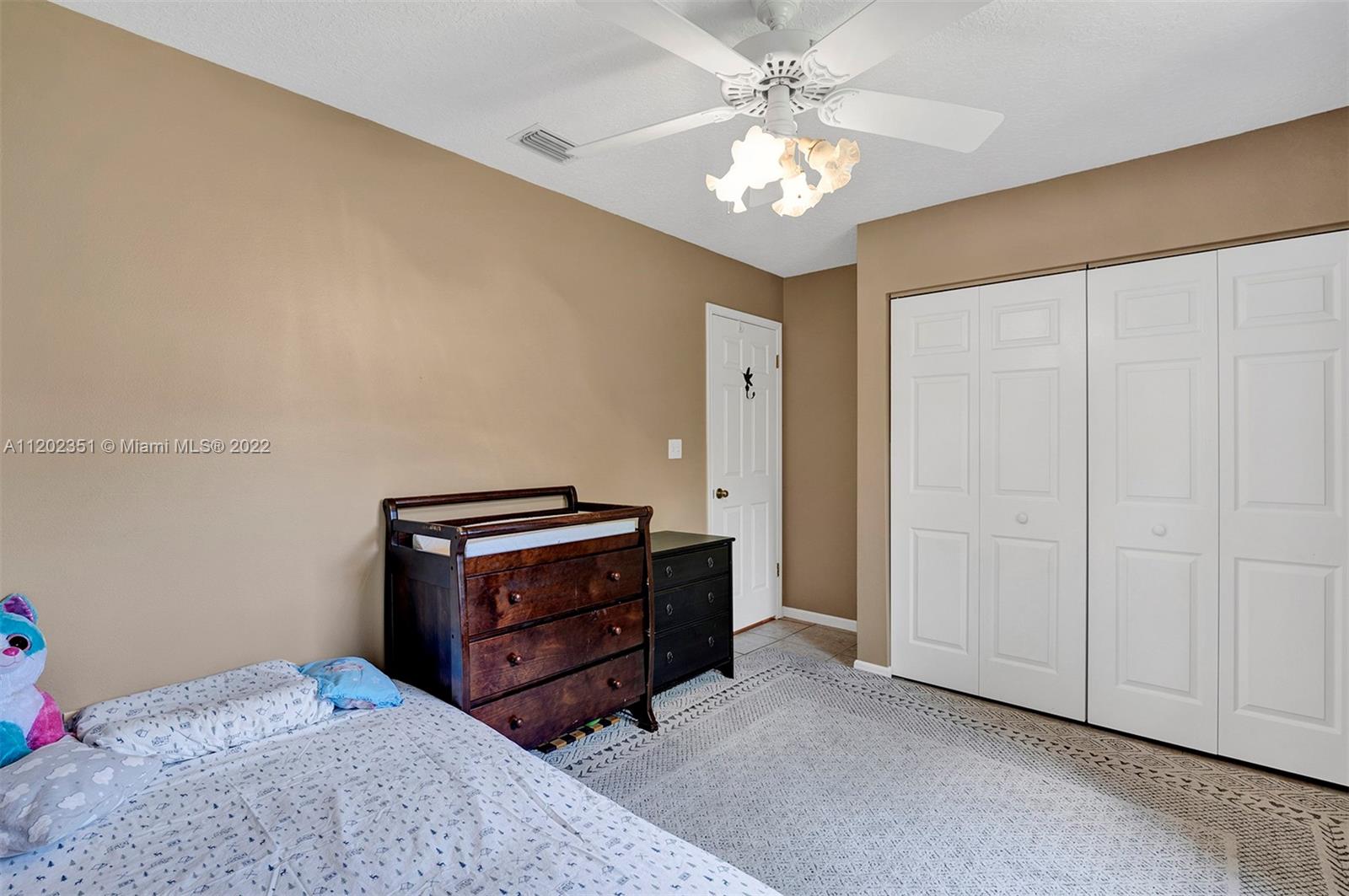 12801 Southwest 148th Street Road Miami, FL 33186 - Photo 16 of 39 a living room with furniture and a chandelier