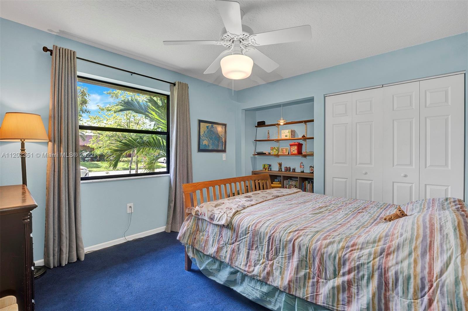 12801 Southwest 148th Street Road Miami, FL 33186 - Photo 17 of 39 a bedroom with a large bed and a large window