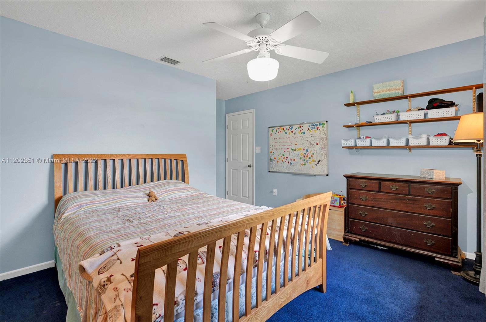 12801 Southwest 148th Street Road Miami, FL 33186 - Photo 18 of 39 a bedroom with a bed and dresser