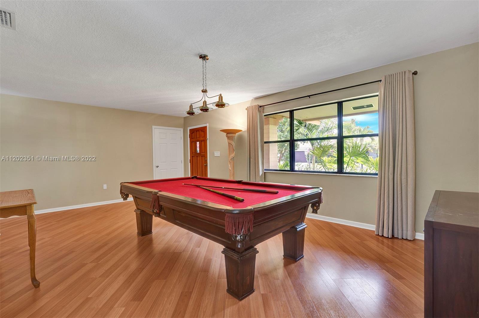 12801 Southwest 148th Street Road Miami, FL 33186 - Photo 20 of 39 a room with pool table window and wooden floor
