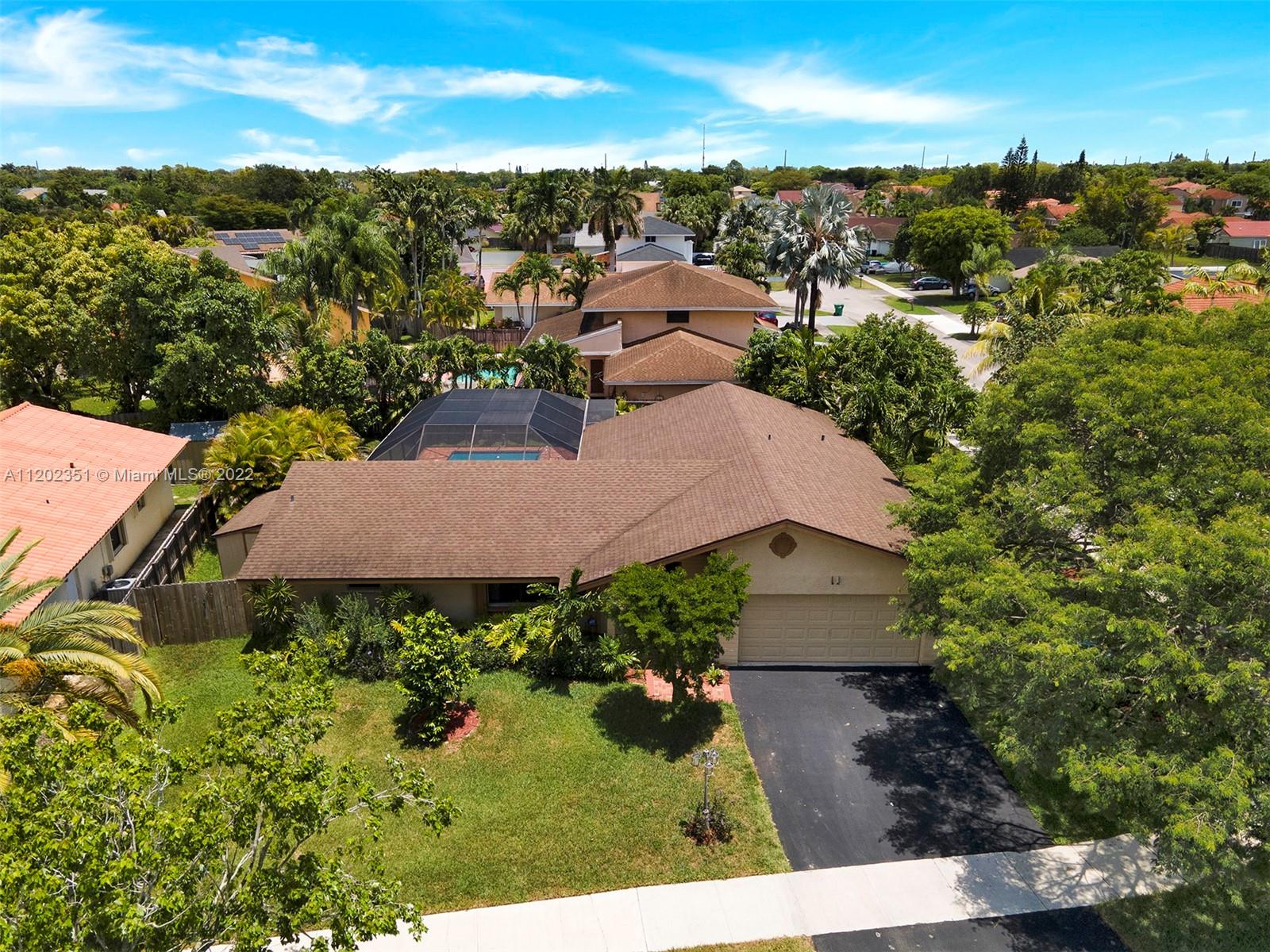 12801 Southwest 148th Street Road Miami, FL 33186 - Photo 2 of 39 an aerial view of a house with a yard and lake view