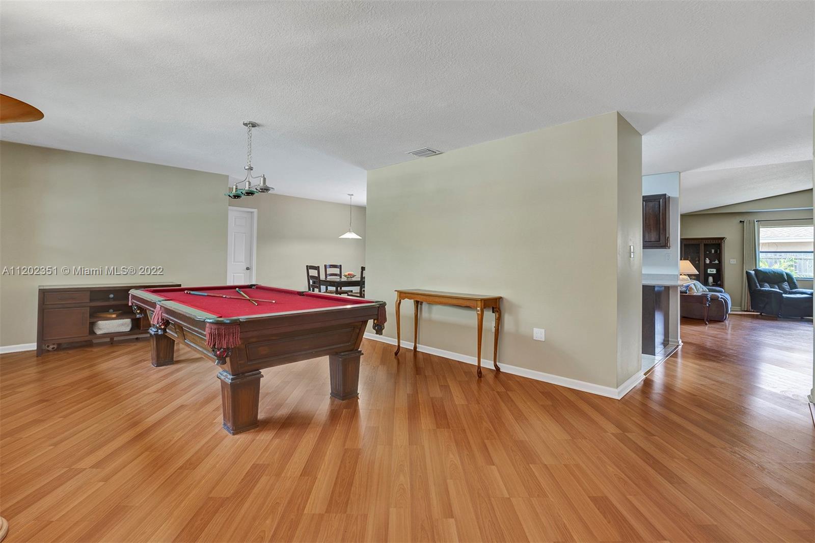 12801 Southwest 148th Street Road Miami, FL 33186 - Photo 21 of 39 a room with wooden floor pool table and chairs