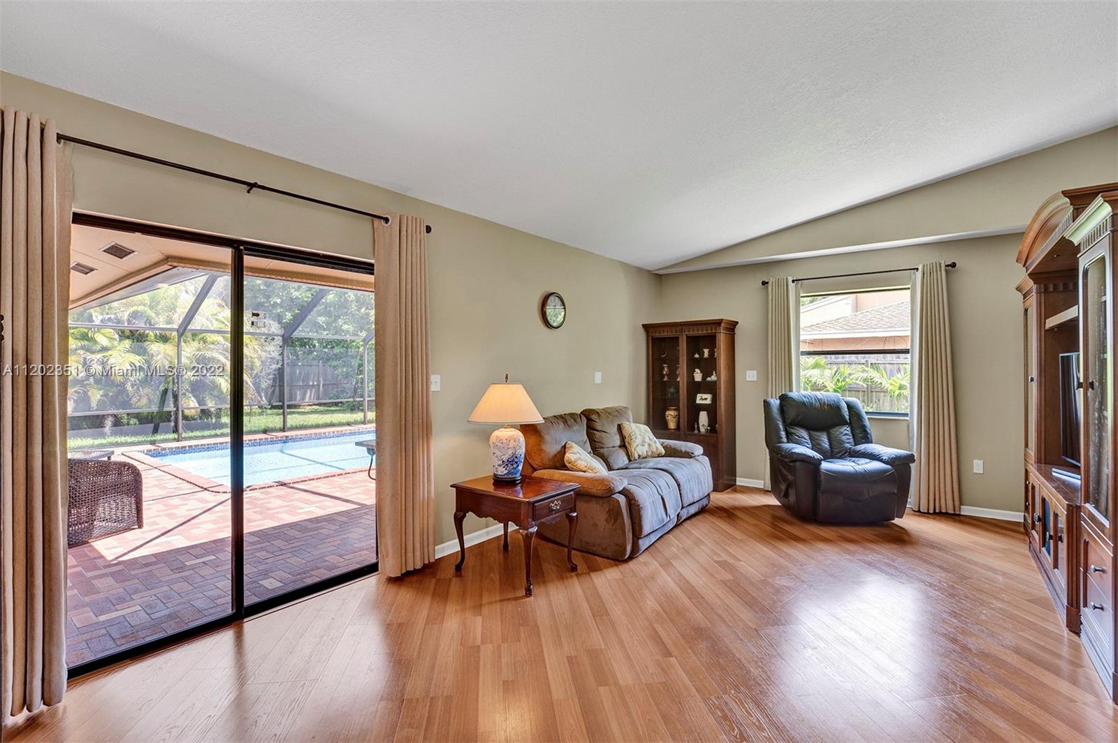 12801 Southwest 148th Street Road Miami, FL 33186 - Photo 23 of 39 a living room with furniture and a large window