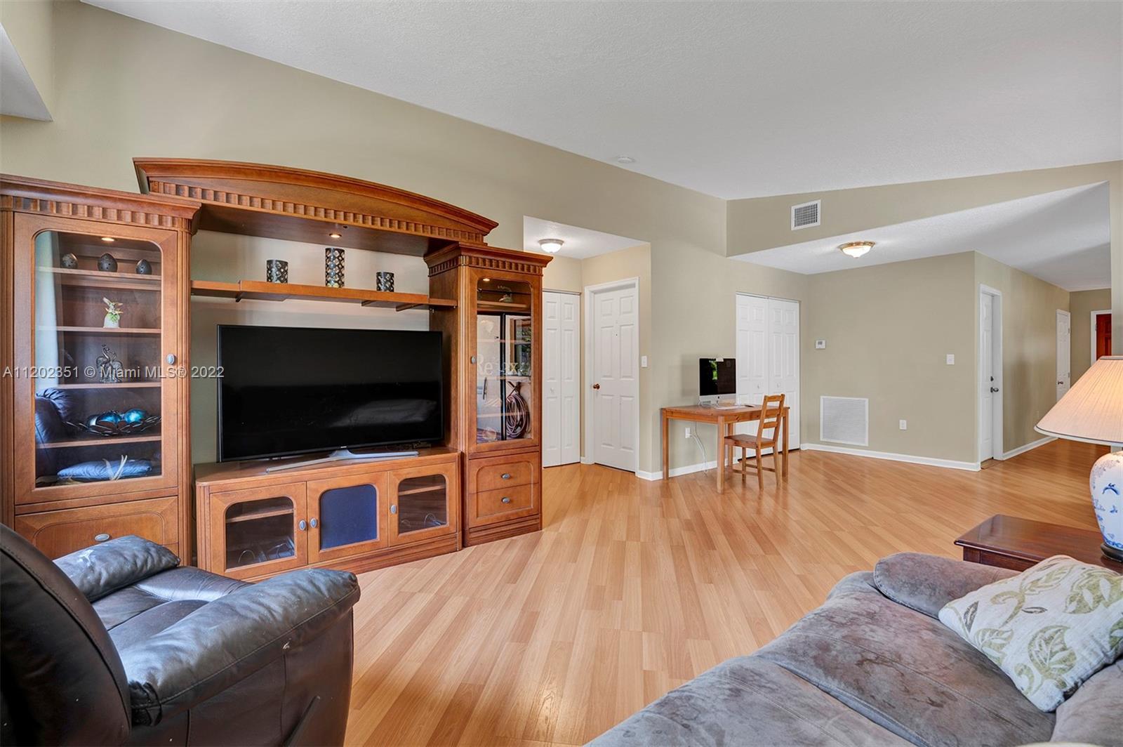 12801 Southwest 148th Street Road Miami, FL 33186 - Photo 24 of 39 a living room with furniture and a flat screen tv