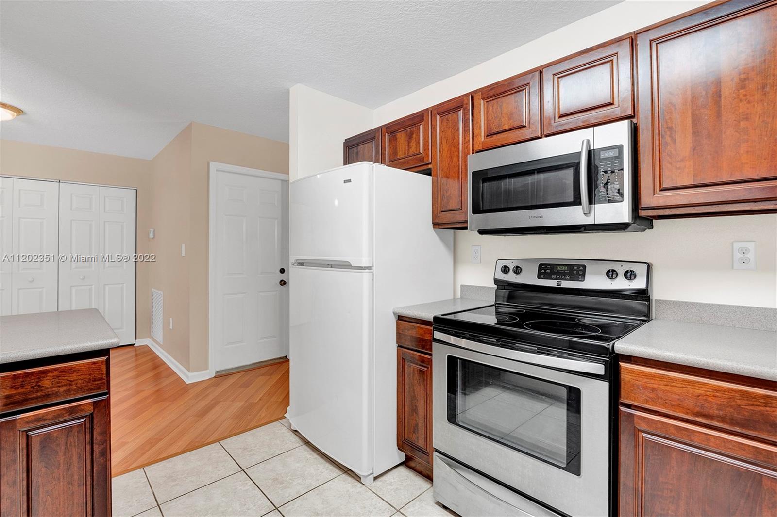 12801 Southwest 148th Street Road Miami, FL 33186 - Photo 8 of 39 a kitchen with stainless steel appliances a stove microwave and refrigerator