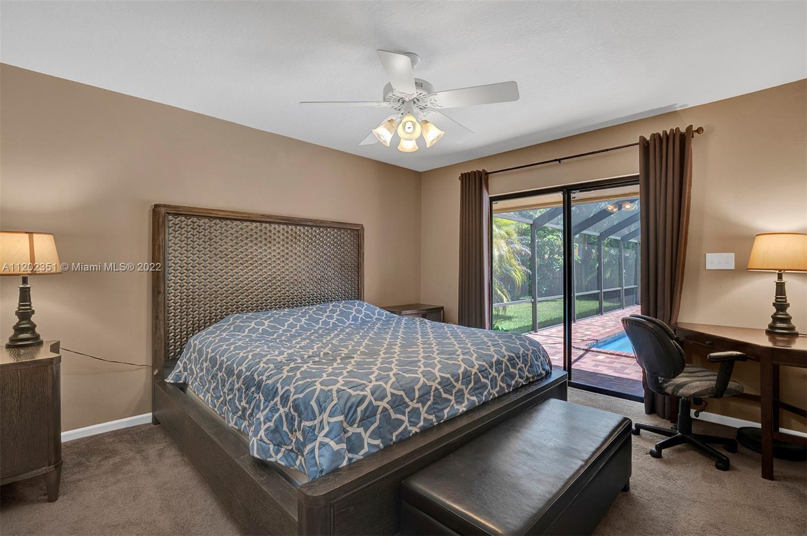 12801 Southwest 148th Street Road Miami, FL 33186 - Photo 10 of 39 a bedroom with a bed and a table