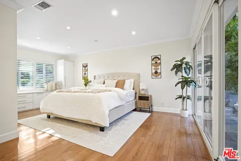 a spacious bedroom with a bed and a large window