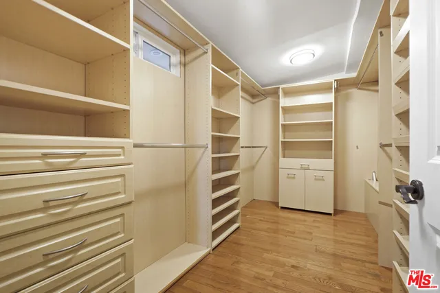 a view of walk in closet with empty racks