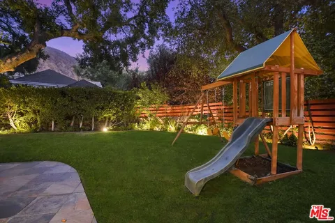 a view of a house with a backyard